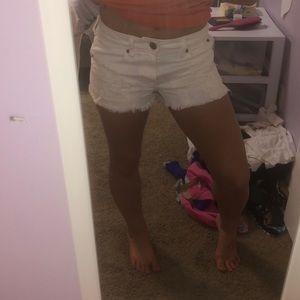 Distressed white jean shorts